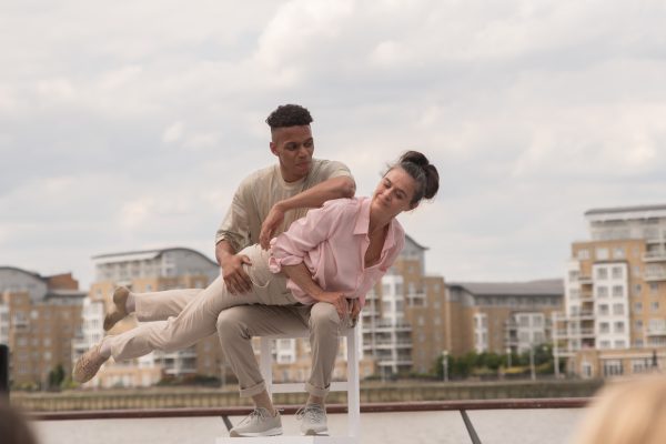 An image of a male and female dancer with a city scape behind.