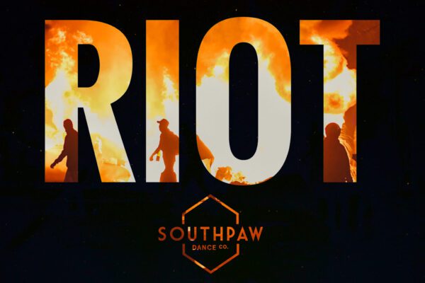 An image of the word RIOT against a black background. Within the letters there are flames and people walking among them.