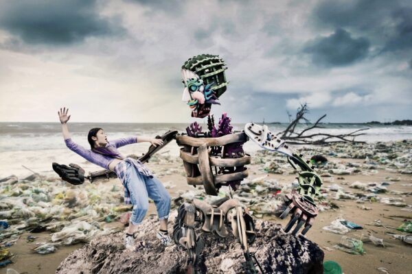 Eko and Violet are on a beach covered in plastics and litter.