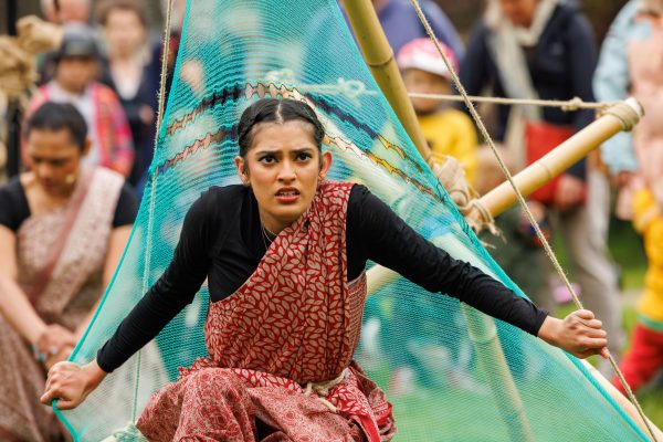 An image of a female performer wearing traditional Indian dress