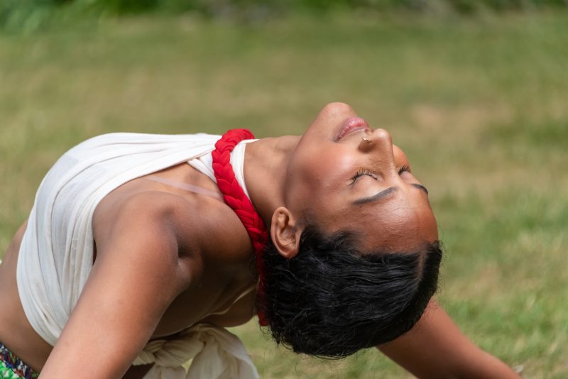 A close up image of a South Asian female leaning backwards.